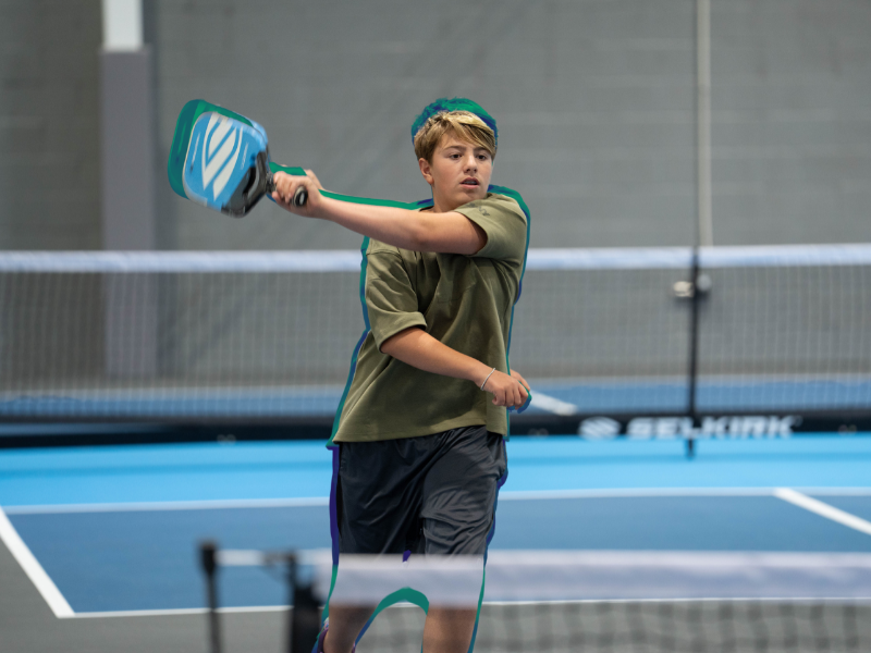 kid playing pickleball
