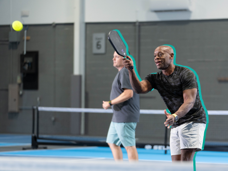 Guy serving a pickleball